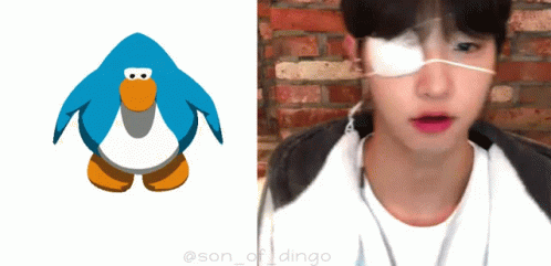 a young man wearing blue with glasses next to an animated bird