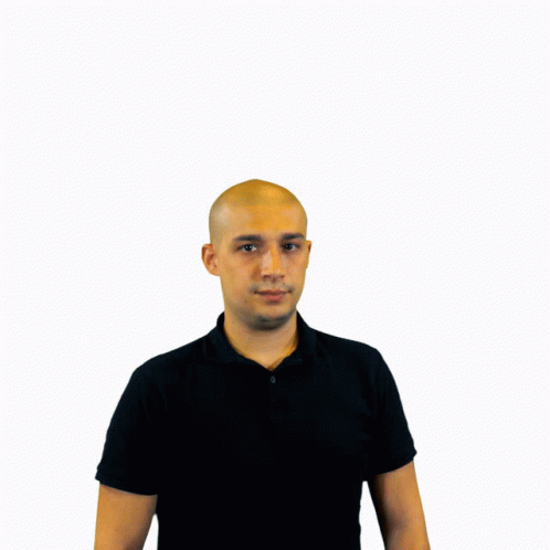 a man wearing a black shirt standing in front of a white background