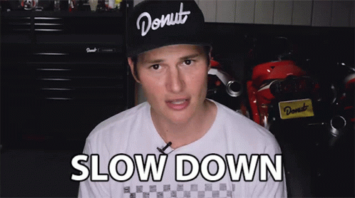 the young man is wearing a hat that says slow down