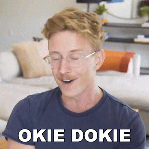 a person smiling and holding soing up to their face with the caption of okie dokie