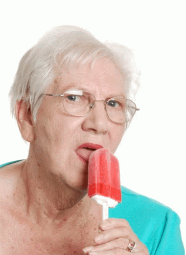 an old lady with glasses and a blue ice cream lollypop