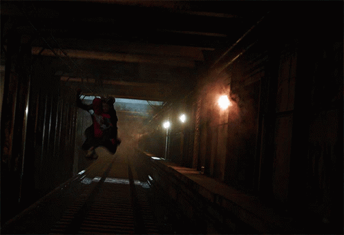 a skateboarder in a dark tunnel doing tricks