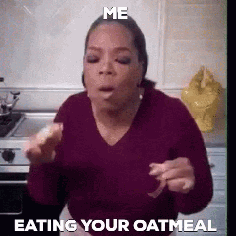 a woman is eating her oatmeal in the kitchen