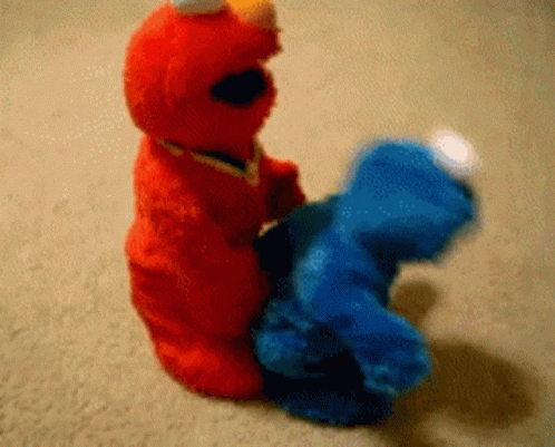 a brown stuffed animal and blue teddy bear on the floor