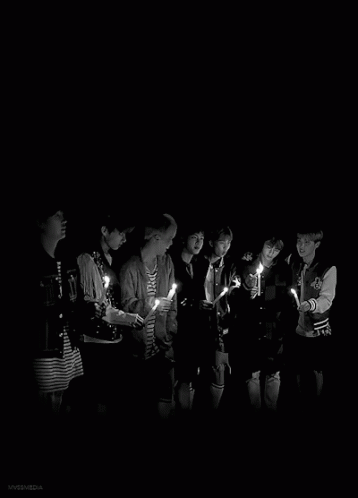 a large group of people who are standing in the dark