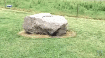 some rocks are on some grass in a field