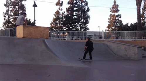 a skateboarder going down the side of the ramp