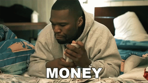 an african american man holding money while looking at a phone