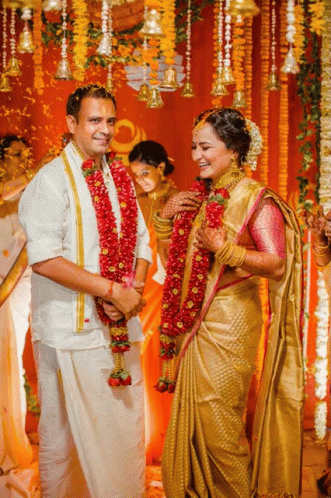 a couple holding hands during an indian wedding
