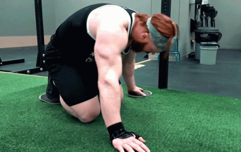 the person is using both hands to h up against a mat