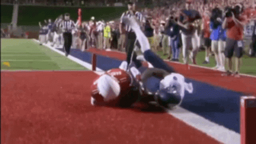 a football player is doing a flip while on the ground