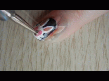 a manicure is being held up to the nail