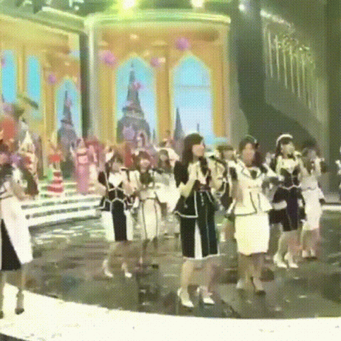 a group of people in fancy clothes on a stage