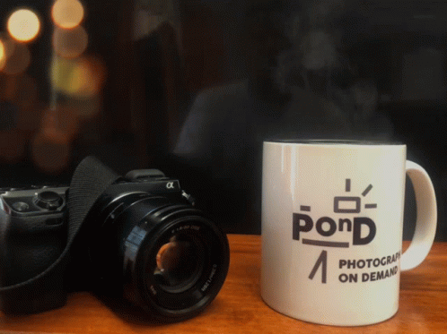 a camera and coffee mug that reads, pdrd