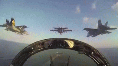 four fighter jets flying over each other in an overhead view