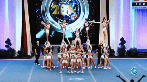 the group of cheerleaders are posing on stage