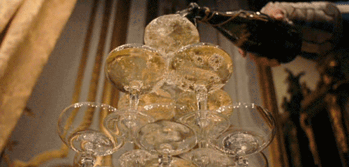 a stack of clear glass cups on top of a wooden table