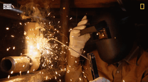 someone welding soing into a pipe with his hands