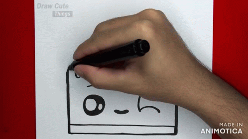 an adult's hand drawing on paper with a marker