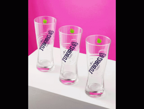 three glasses are shown on a table and purple background