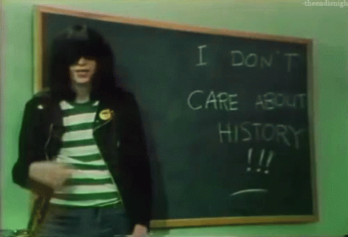 the man is in front of a chalkboard with the words i don't care about history on it