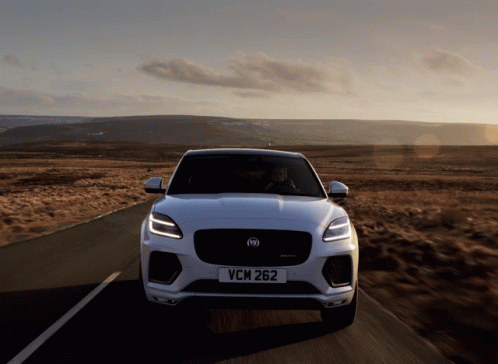 the new jaguar cars is being driven on a road