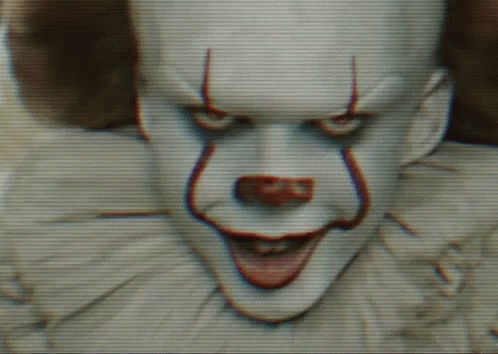 a clown has an odd face and white hair
