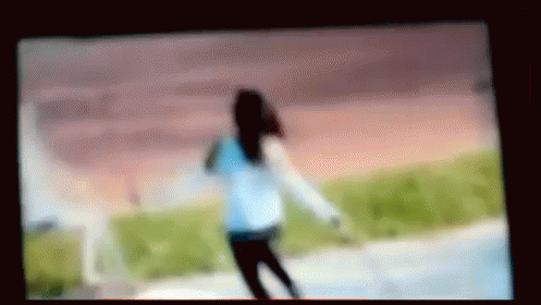 this blurry po shows a young woman walking on the beach