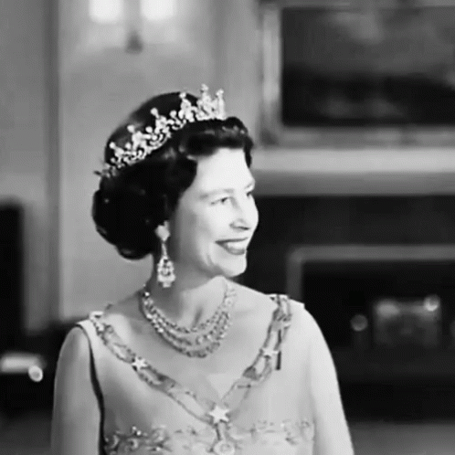 a black and white image of a woman wearing a tiara