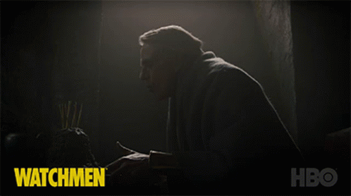man in dark room with text that reads watchmen