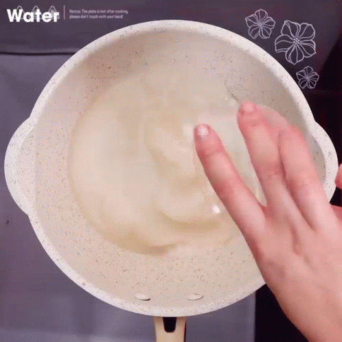 a persons hand on top of a bowl