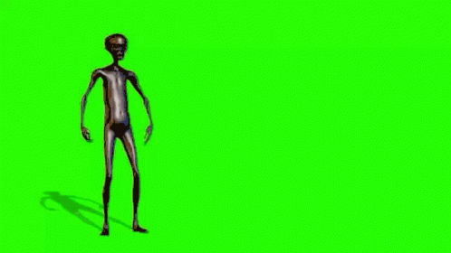 an alien like body, standing against a green background