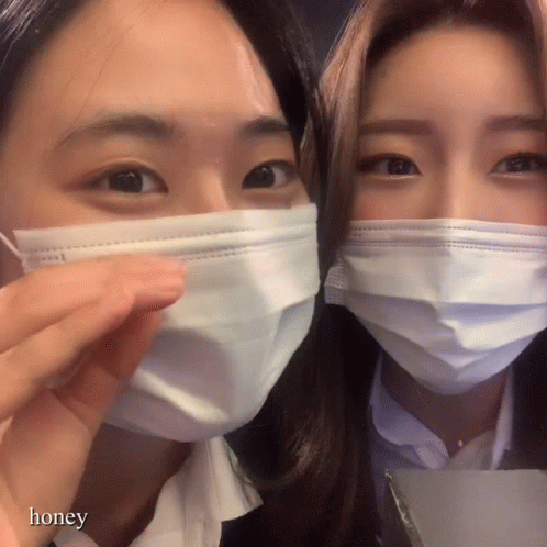 two women with surgical masks on their face