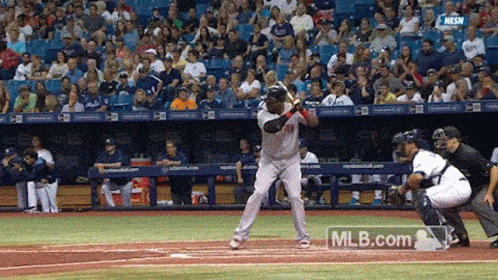 a baseball player swings and misses the ball