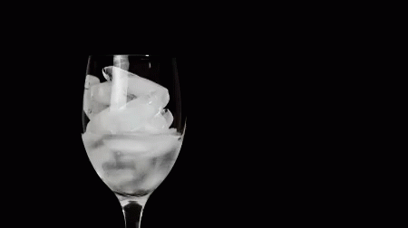 ice in wine glass on a dark background