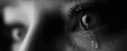 close up of a persons eye and tears