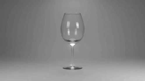 a white wine glass on a table top