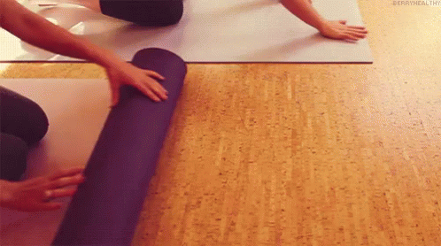 two hands are shown on a yoga mat while someone bends their knees
