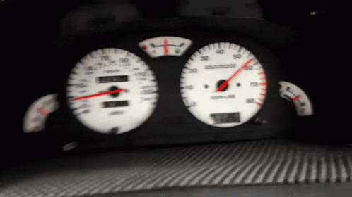 a dashboard with a blue needle showing the speed and distance of different cars