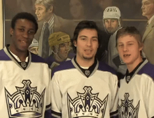 three hockey players in jersey and hats are posing for a picture