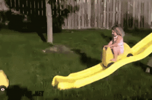 a little girl with a slide in a yard