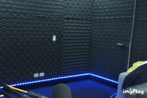 a recording studio with microphones and lights in a darkened room