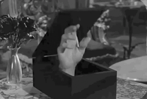 a black and white po of hands in a box