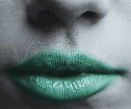 a black and white po of green lipstick