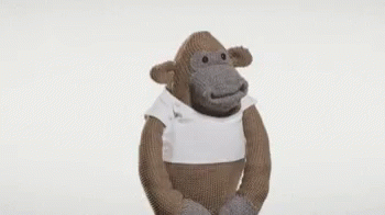 a monkey with a white shirt on is standing in a position