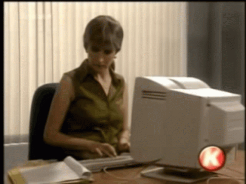 woman using an old computer with floppy disk drive