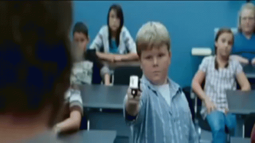 a blurry image of a child holding a cell phone
