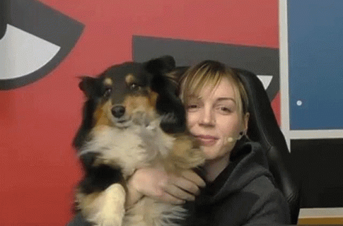 a woman and her dog are posing for the camera