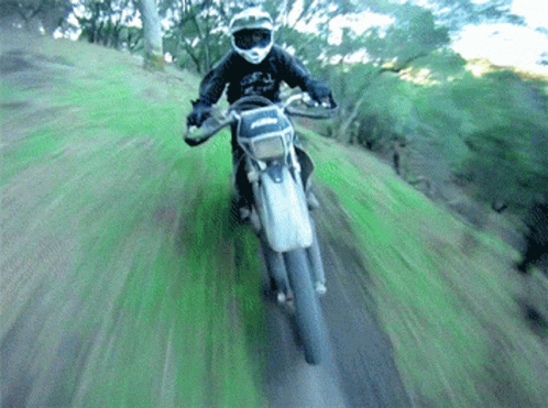 a man on a motorcycle on some dirt