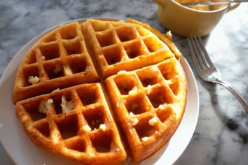a plate that has some waffles on it